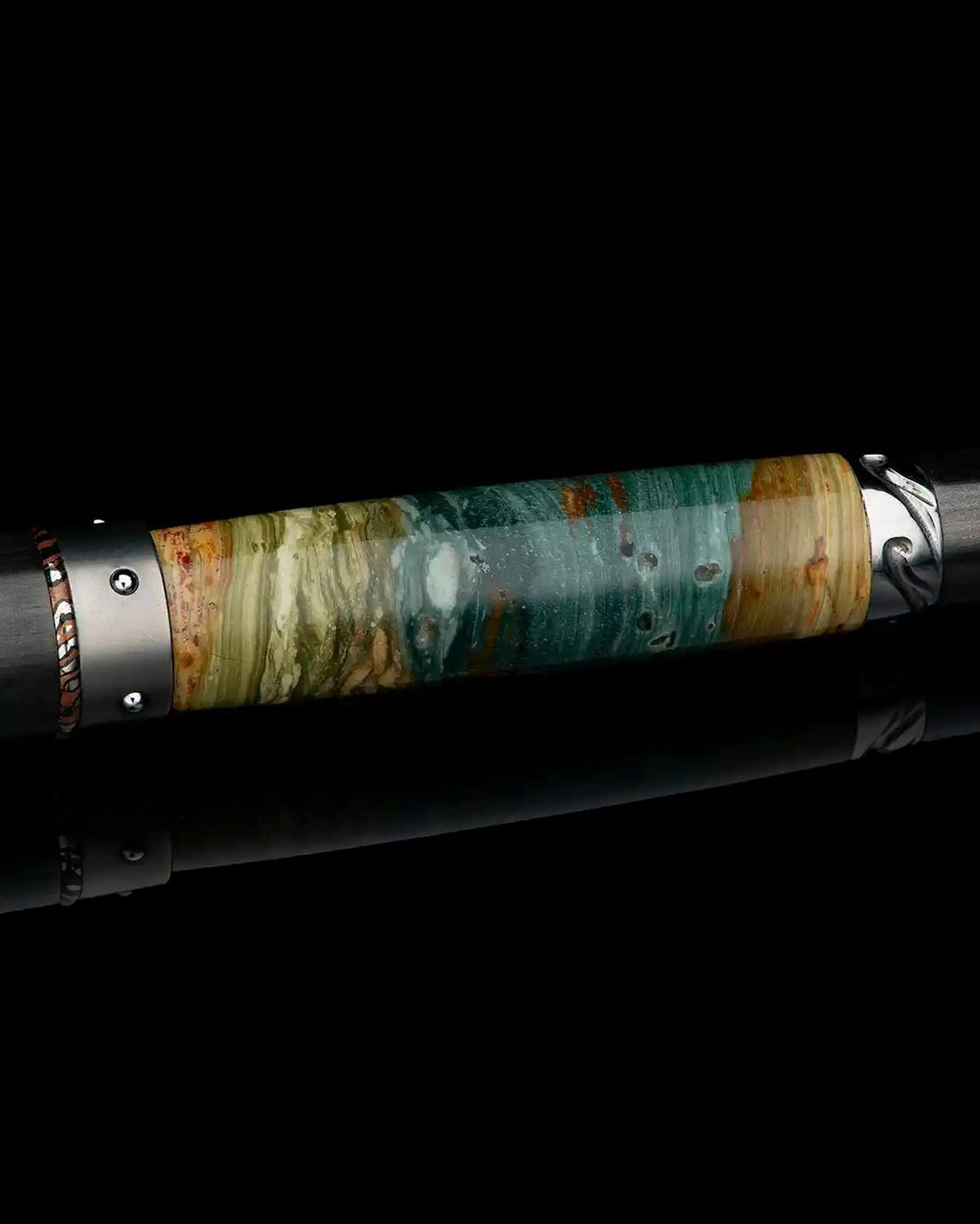 The Cabernet Petrified Pen by William Henry is a luxury pen and distinctive gift for men, featuring a barrel in Gary Green petrified wood with accents in mokume gane, carbon fiber, sterling silver, and white topaz. It includes an aerospace-grade titanium and aluminum structure and uses William Henry’s Wavelock™ cap closure system. Explore more luxury pens and gifts for men online or in-store at Green Lake Gallery, located in Seattle and Bellevue.