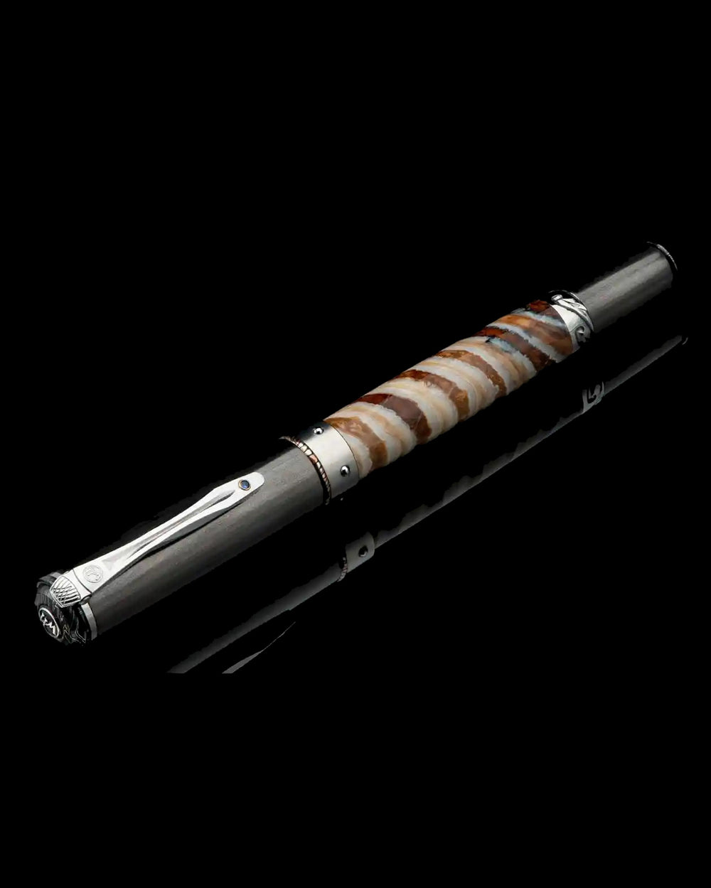 The Cabernet Mammoth Pen by William Henry is a luxury pen and gift for men, featuring a barrel made from fossilized woolly mammoth tooth with a titanium and aluminum structure. Accents include mokume gane, carbon fiber, sterling silver, and a sapphire-set pocket clip. Explore more luxury pens and gifts for men online or in-store at Green Lake Gallery, located in Seattle and Bellevue.