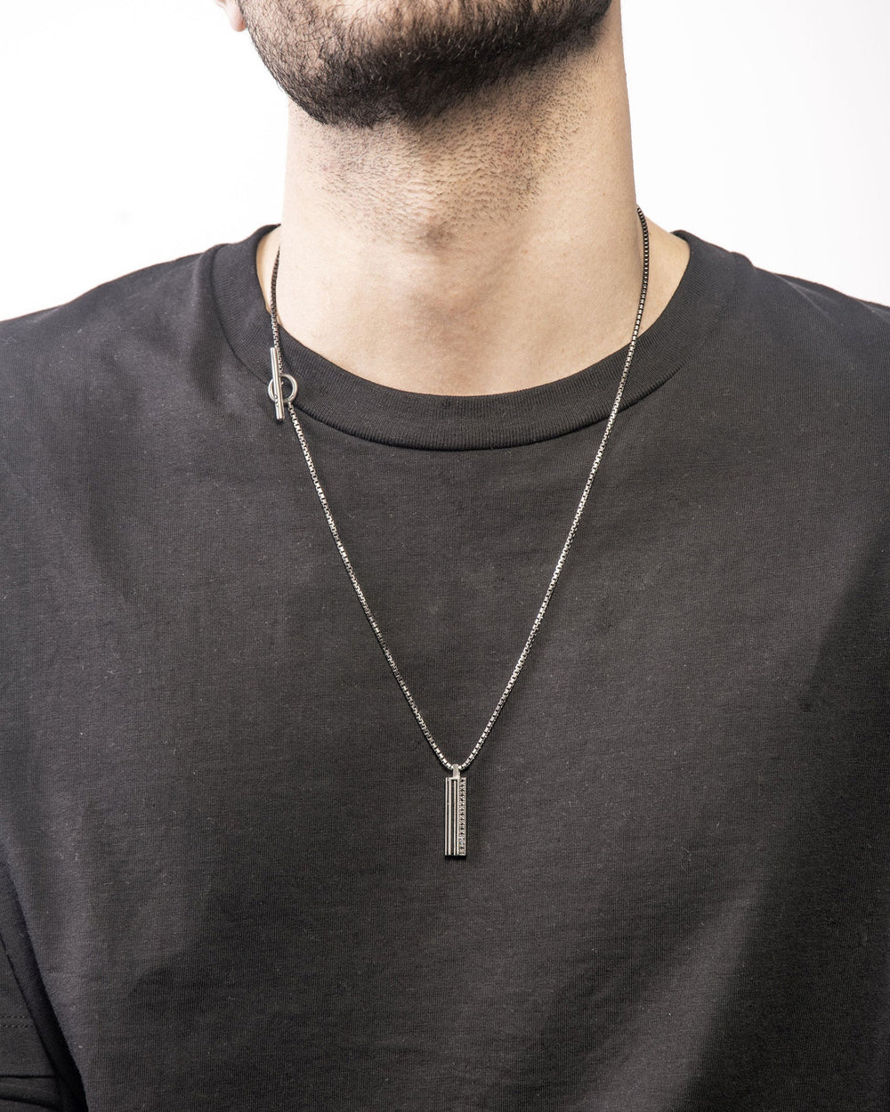 The Triple Black pendant by Marco Dal Maso is a great luxury jewelry gift for men, crafted in oxidized silver with black enamel detailing and black diamonds. Shown worn on a 24 inch chain with a circle and rod toggle clasp. Made in Italy. Explore more luxury gifts for men, including pendants, bracelets, watches, and accessories. All items are available online or in-store at Green Lake Gallery, located in Seattle and Bellevue.