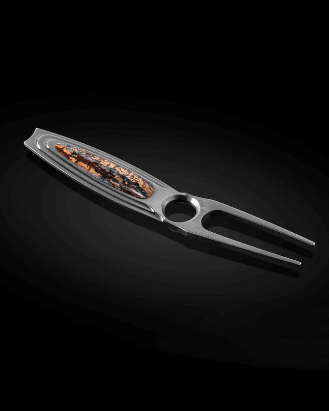 Luxury golf tool crafted from aerospace-grade titanium with a fossilized woolly mammoth tooth inlay and brown anodized accents. Features a chamfered thumb rest and includes a leather carry case. A distinctive gift for men. Explore more luxury gifts for men, including golf tools, money clips, watches, bracelets, and pens. All items are available online or in-store at Green Lake Gallery, located in Seattle and Bellevue.