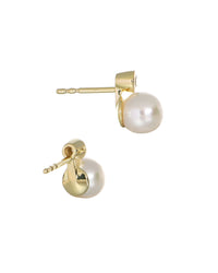 side view of white pearl set on gold earrings with a small diamond on top. on a white background