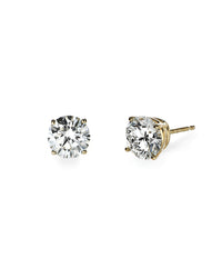 diamond studs set in yellow gold. on white background