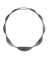 Silver necklace with leaf-like pendants on a white background